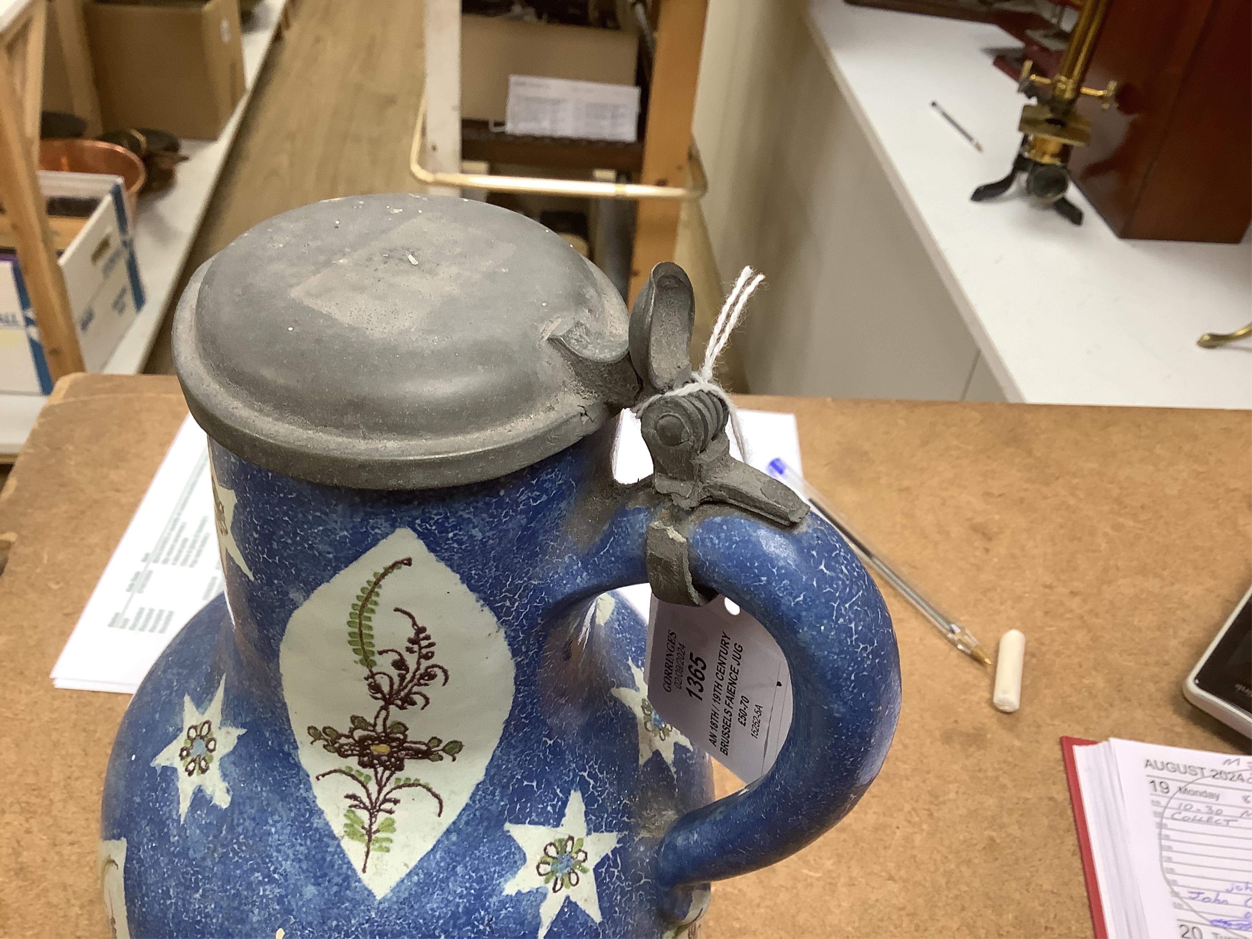 An 18th / 19th century Brussels faience jug and a French Quimper faience pottery jug, largest 25cm high. Condition - fair to good